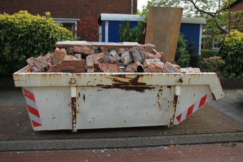Construction site with waste being cleared in Gipsy Hill