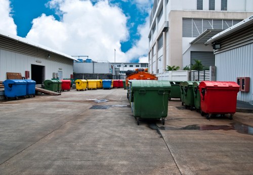 Workers loading waste into a skip